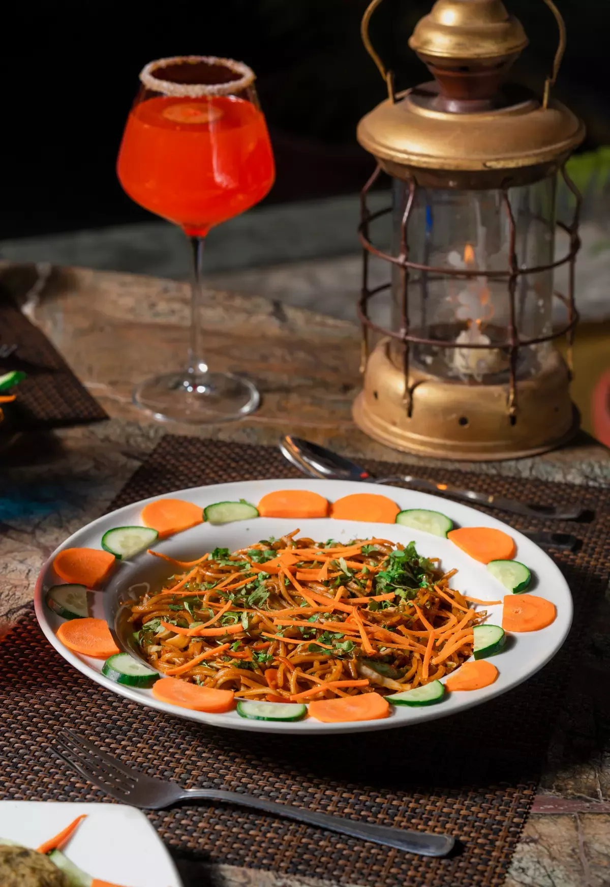 Mocktail and noodles by lantern light